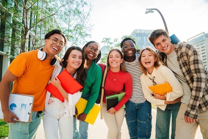 Students laughing together on campus before the LUVEI Community Meetup